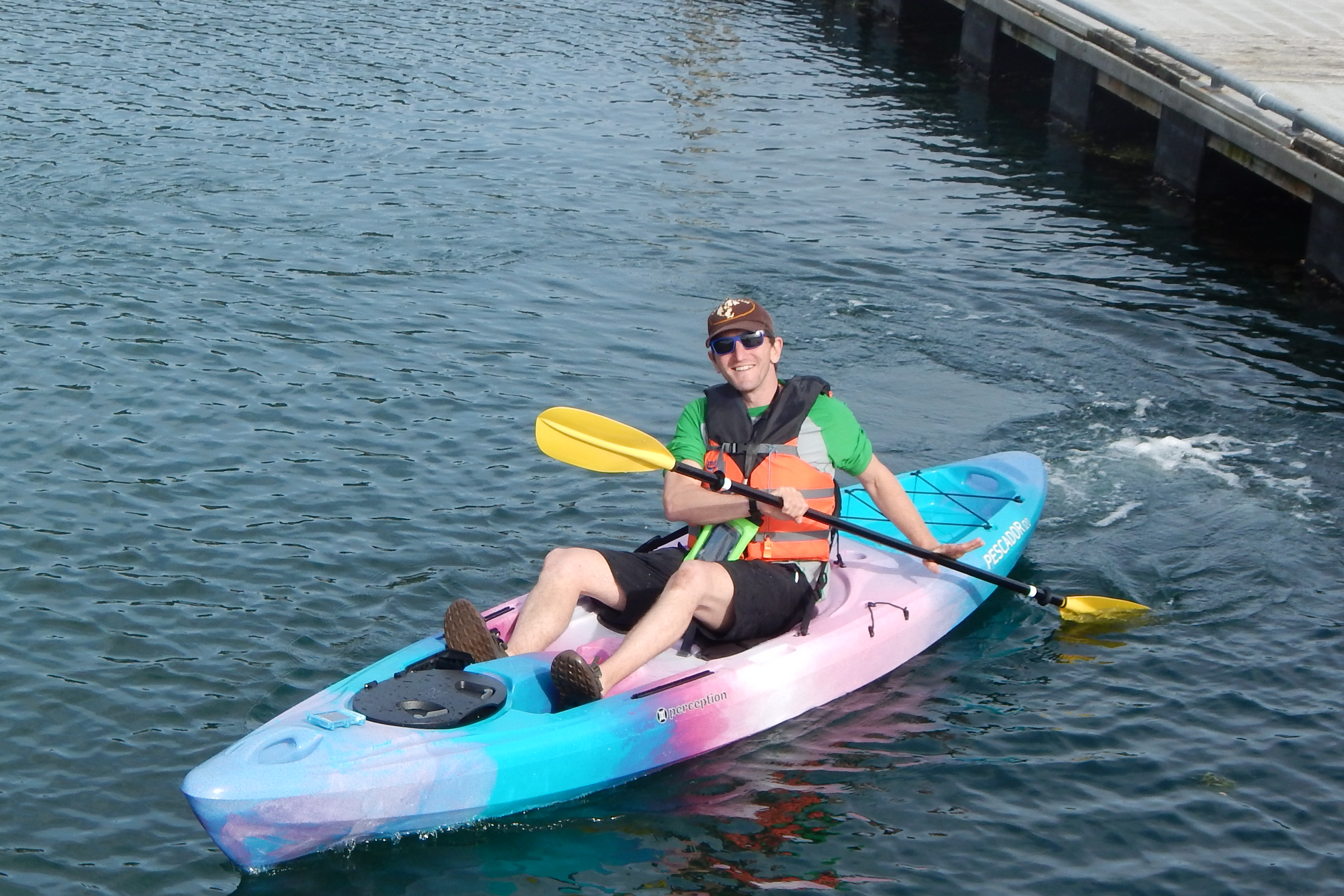 Woman paddles single sit-on-top kayak